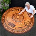 Margie Manning admires an ornate, nautical-themed dining table, built by her late husband Peter,...