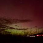 Aurora Australis over Matakaea/Shag Point on Saturday night, with the tail lights of a car...