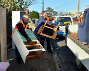 Flood-damaged furniture is removed from a Nelson St house following the 2015 South Dunedin flood....