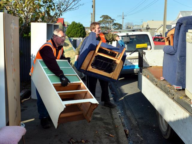 Flood-damaged furniture is removed from a Nelson St house following the 2015 South Dunedin flood....