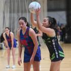 College centre Poppy Kilworth  prepares to pass in front of University-Albion wing defence Talia...