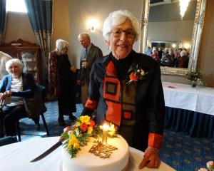 Barbara Simpson prepares to cut her birthday cake adorned in her favourite colours at the Brydone...