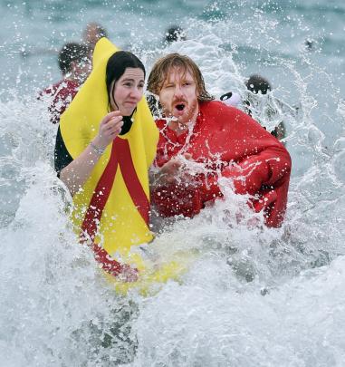 Maia Alderson and Joe Duggan, both of Dunedin, brave St Clair’s icy surf.