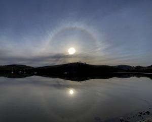 The 22° halo is reflected in the water at Portobello. Photo: Ian Griffin