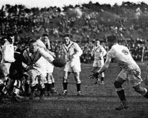 An English player offloads during the rugby league test against the Kiwis in 1924 while...