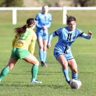 Rose Morton of the Dunedin City Royals slips past Cashmere's Margi Dias in a game in July. PHOTO:...