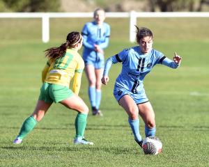 Rose Morton of the Dunedin City Royals slips past Cashmere's Margi Dias in a game in July. PHOTO:...