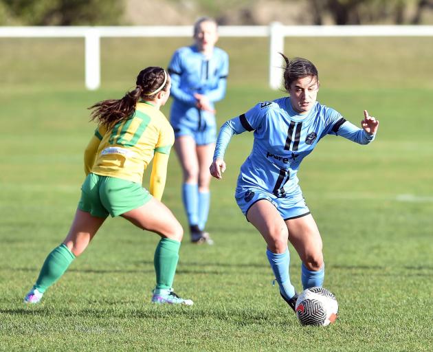 Rose Morton of the Dunedin City Royals slips past Cashmere's Margi Dias in a game in July. PHOTO:...