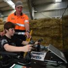 Balclutha’s Mike Hurring Logging and Contracting employee Josh Hurring shows Dunedin school pupil...