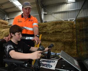 Balclutha’s Mike Hurring Logging and Contracting employee Josh Hurring shows Dunedin school pupil...