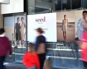 Signs in George St outside the Wall St Mall tease the arrival of Seed Heritage to the city.