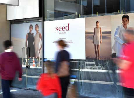 Signs in George St outside the Wall St Mall tease the arrival of Seed Heritage to the city.