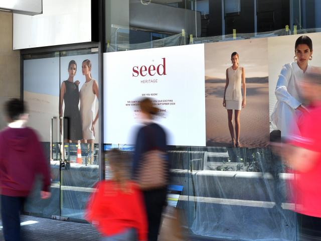 Signs in George St outside the Wall St Mall tease the arrival of Seed Heritage to the city.