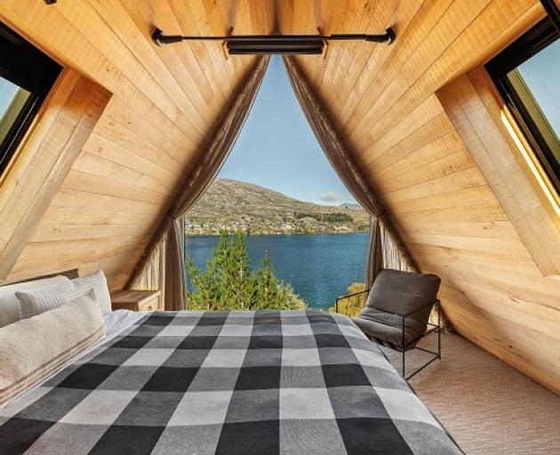 A large triangular window offers expansive views of the lake.