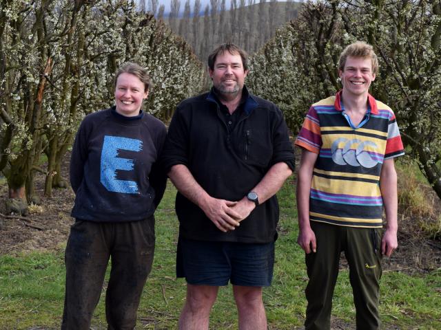 Standing among plum trees on Waitaki Orchards in North Otago are (from left) general manager...