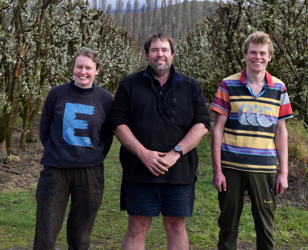 Standing among plum trees on Waitaki Orchards in North Otago are (from left) general manager...