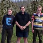 Standing among plum trees on Waitaki Orchards in North Otago are (from left) general manager...