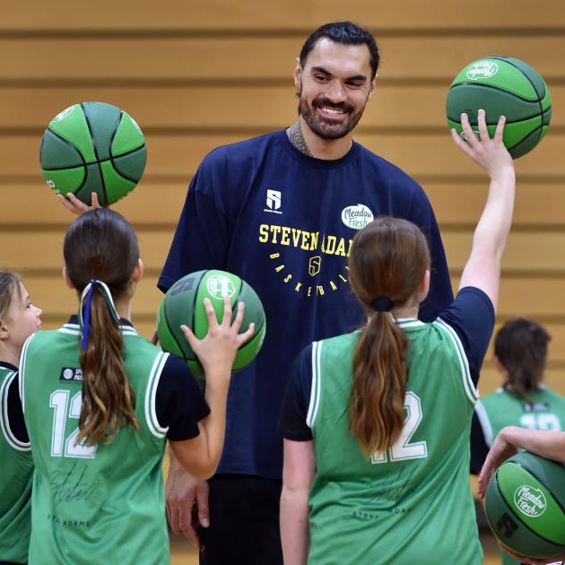 New Zealand NBA star Steven Adams charms some children during his basketball camp at the Edgar...