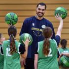 New Zealand NBA star Steven Adams charms some children during his basketball camp at the Edgar...