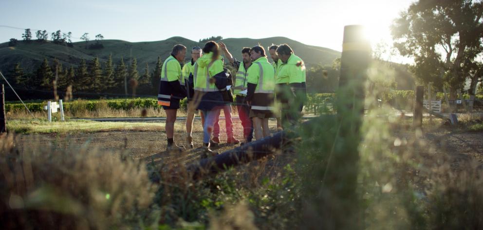 Marlborough viticulturist Stu Dudley talks to the vineyard team before they start work early.