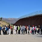 Migrants at the US-Mexico border queue for admission to the United States. PHOTO: GETTY IMAGES